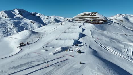 Aerial-View-of-Livigno-Ski-Resort,-Italy,-Snowy-Landscape-and-Ramps-From-Freestyle-Skiing