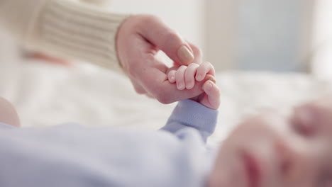 Parents,-family-and-holding-hands-with-baby-on-bed