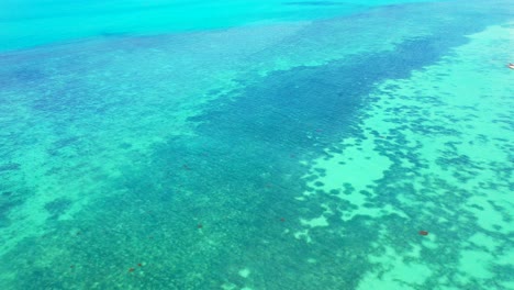 sea texture, blue turquoise water with coral reef and white sand on the seafloor