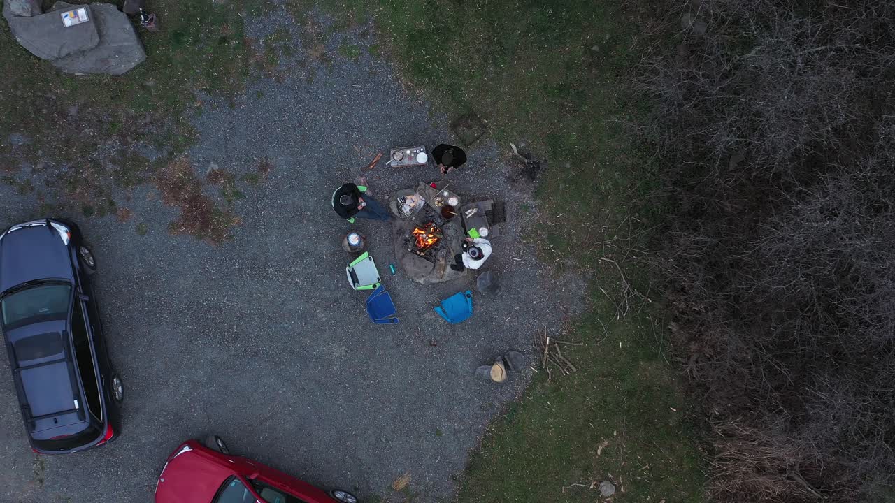 Friends gathered around a campfire at night
