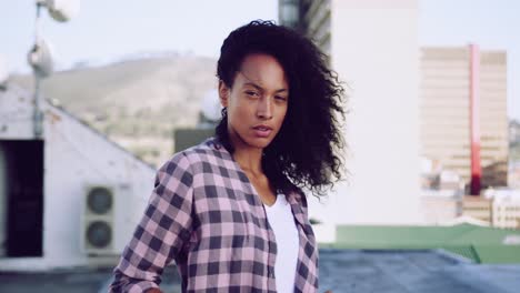 Fashionable-young-woman-on-urban-rooftop