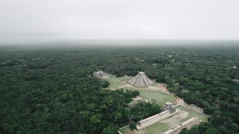 drone flying away from chichen itza aerial