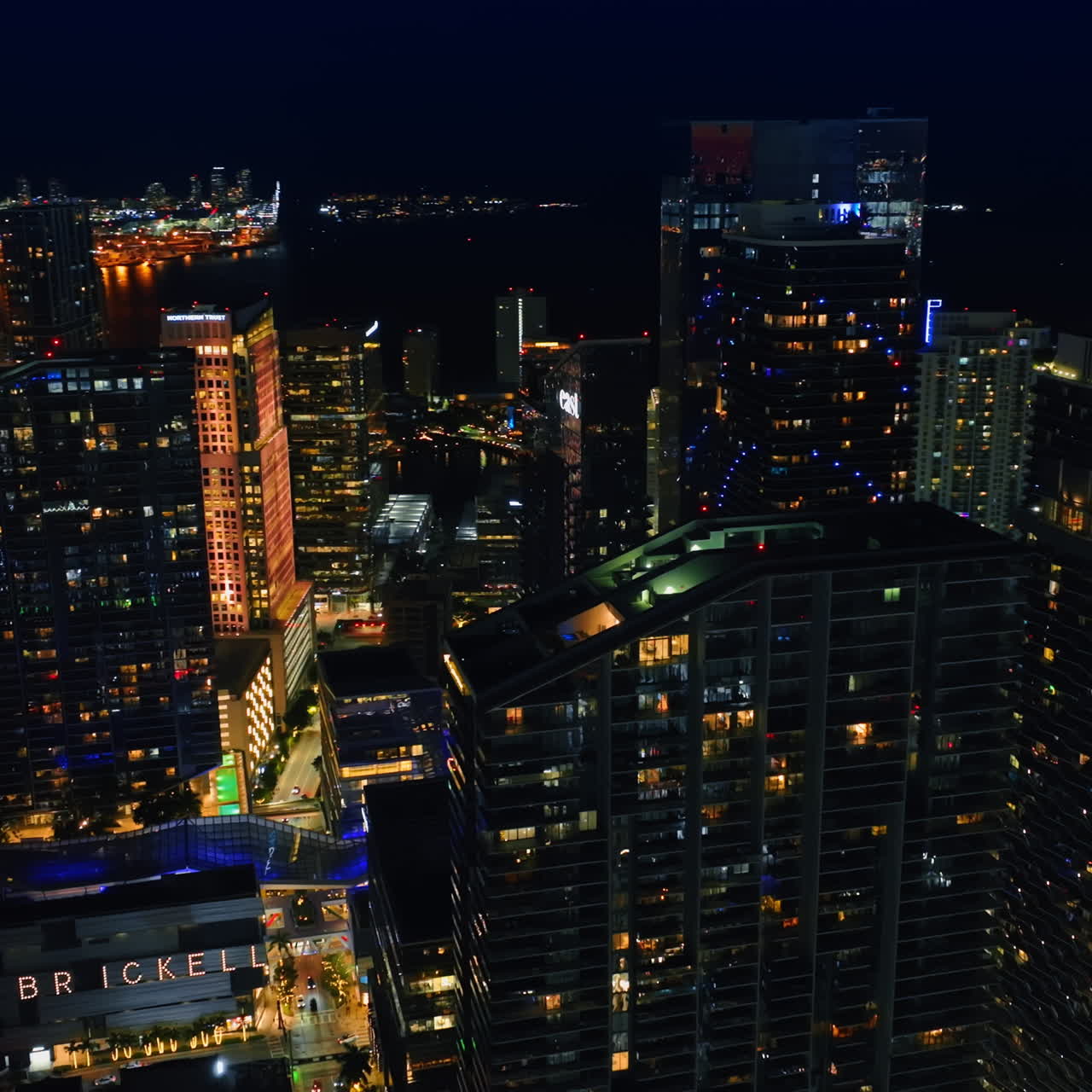 Drone flying around the wonderful skyscrapers at night. Gorgeous view of Miami, Florida, USA.