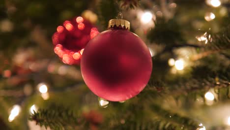 red decoration ball ornament on christmas tree in 4k