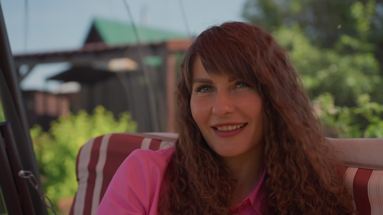 Caucasian Mother Smiling With Child Outside, Loving Mother Enjoying Playful Summer Time Outdoors, Warm Sunlight Bathes Joyful Caucasian Mother As Her Child Swings Happily In Garden
