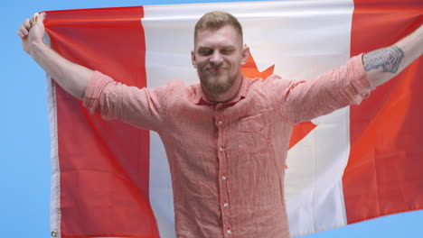 man holding canadian flag