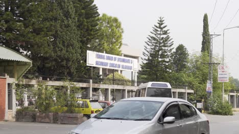 A view of an educational center outside, alongside a busy road.