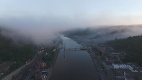 low clouds at dinant city near maas river at sunrise, aerial