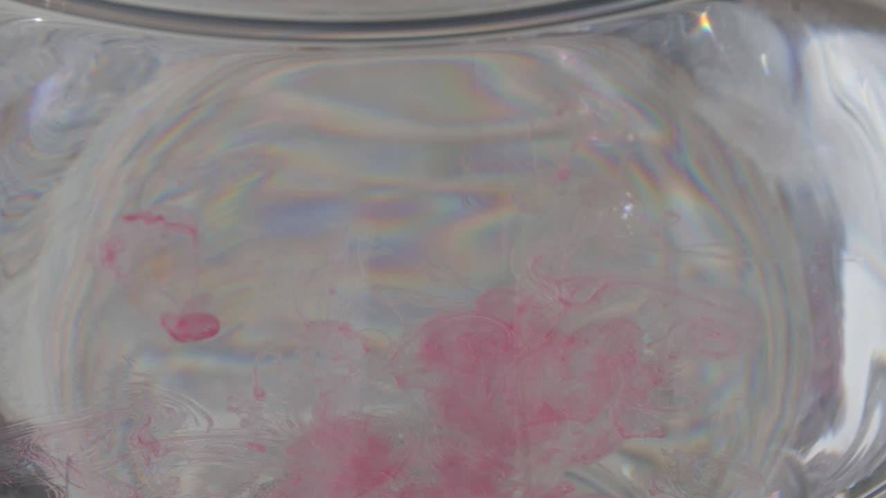 Close Up Of Blood Droplets Falling Into Water In Slow Motion