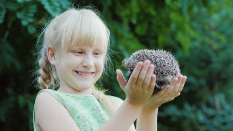 Happy-Blonde-Girl-Holding-A-Hedgehog-Protection-And-Care-Of-Animals-Concept-Slow-Motion-Video