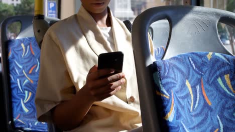 Female-commuter-using-mobile-phone-while-travelling-in-bus-4k