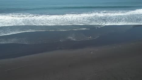 a mesmerizing drone video of a woman dancing on the beach at puerto san jose, showcasing the beauty of the beach and the grace of the dancer