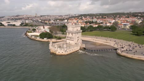 aerial rotating shot of the stunning torre de belém with lisbon behind