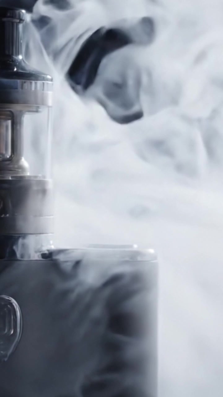 Captivating Moments of Vaporization: A Close-Up Encounter with a Modern Vape Amidst a Cloud of Smoke, Showcasing Its Sleek Design and Functionality.
