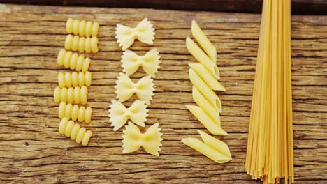 various pasta on wooden table background