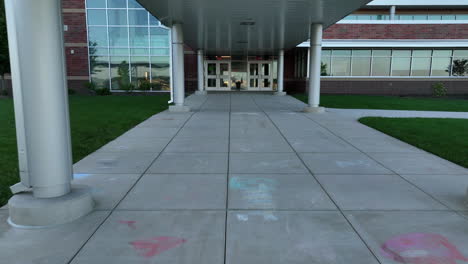 low aerial approach towards school entrance