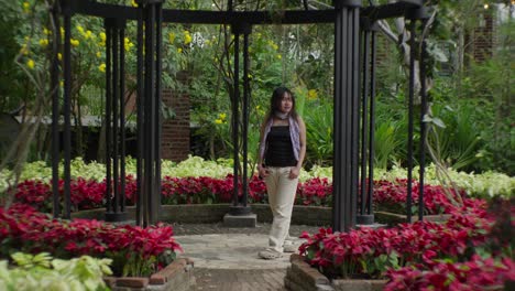 woman standing in a beautiful garden gazebo