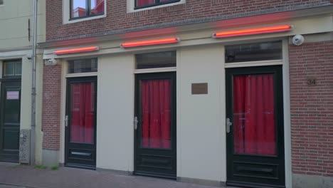 red curtained door windows of oudekerkplein amsterdam red light district de wallen