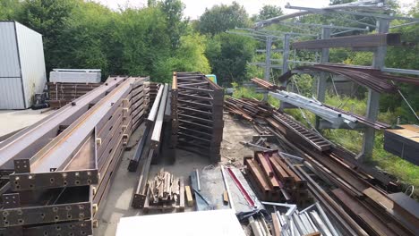 Drone-soars-over-metal-groundwork—a-captivating-aerial-view-of-construction-elements-at-rest-in-this-dynamic-stock-footage