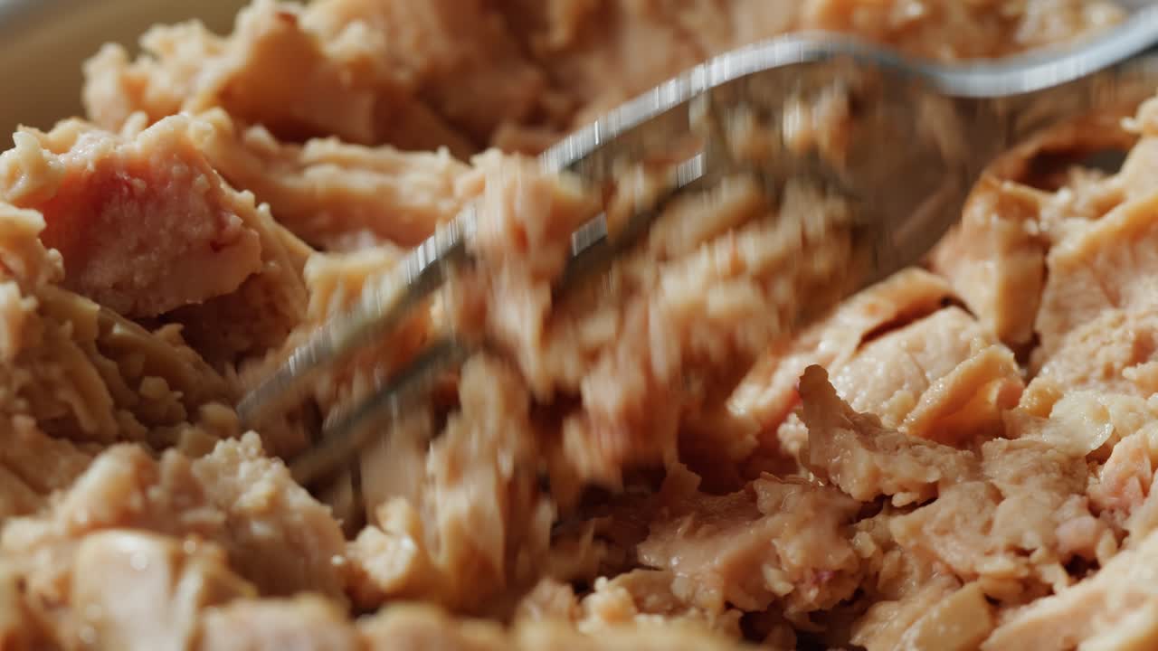 Smoked cod liver in oil in open tin can with fresh greens on wooden table. Seafoods delicacy. High quality 4k footage
