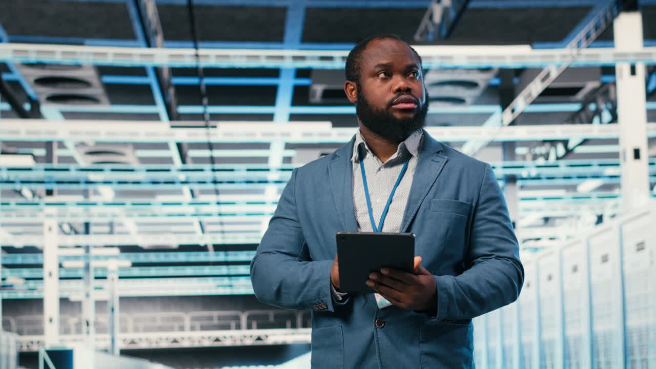 African American IT Engineer Using Tablet in Data Center