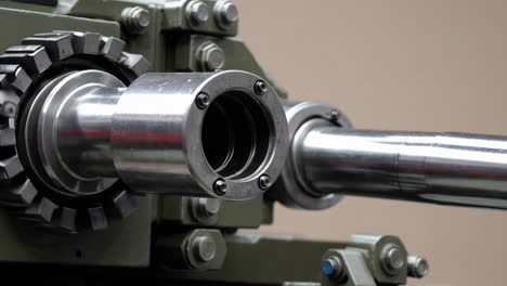 close-up of a military tank gun barrel and mechanism