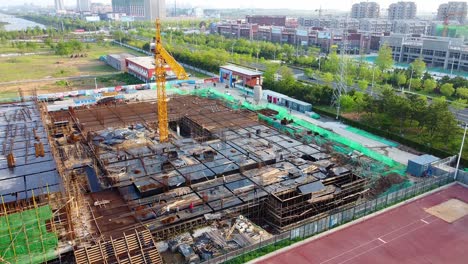 aerial stationary drone shot of people working at big construction site