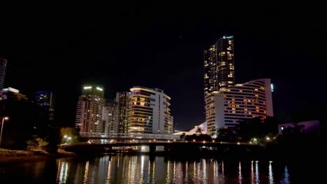 illuminated buildings reflecting on calm water