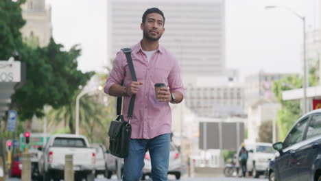 man walking in the city with a coffee