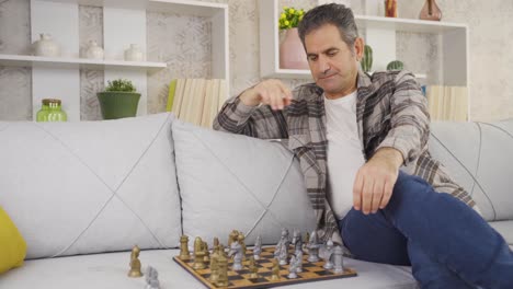 Lonely-and-unhappy-calm-mature-gentleman-playing-chess-alone-at-home.