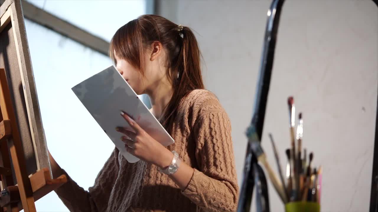 Woman painting at her easel