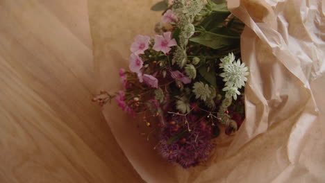 Beautiful-colorful-bouquet-of-flowers-laying-on-a-wooden-table-Top-Shot