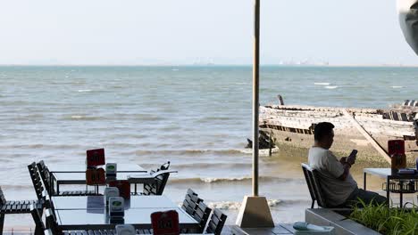 man enjoying view at pattaya beach restaurant