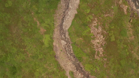 water stream in iceland's westfjords, aerial drone shot