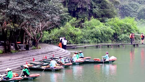 people rowing boats along a scenic river