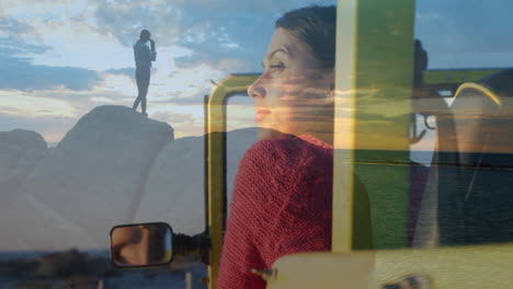 in car, woman in red sweater gazing out window at animation nearby