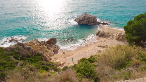 aerial-beautiful-mediterranean-sand-beach-,maresme-barcelona,-san-pol-de-mar,-with-rocks-and-calm-sea-and-turquoise-,-costa-brava