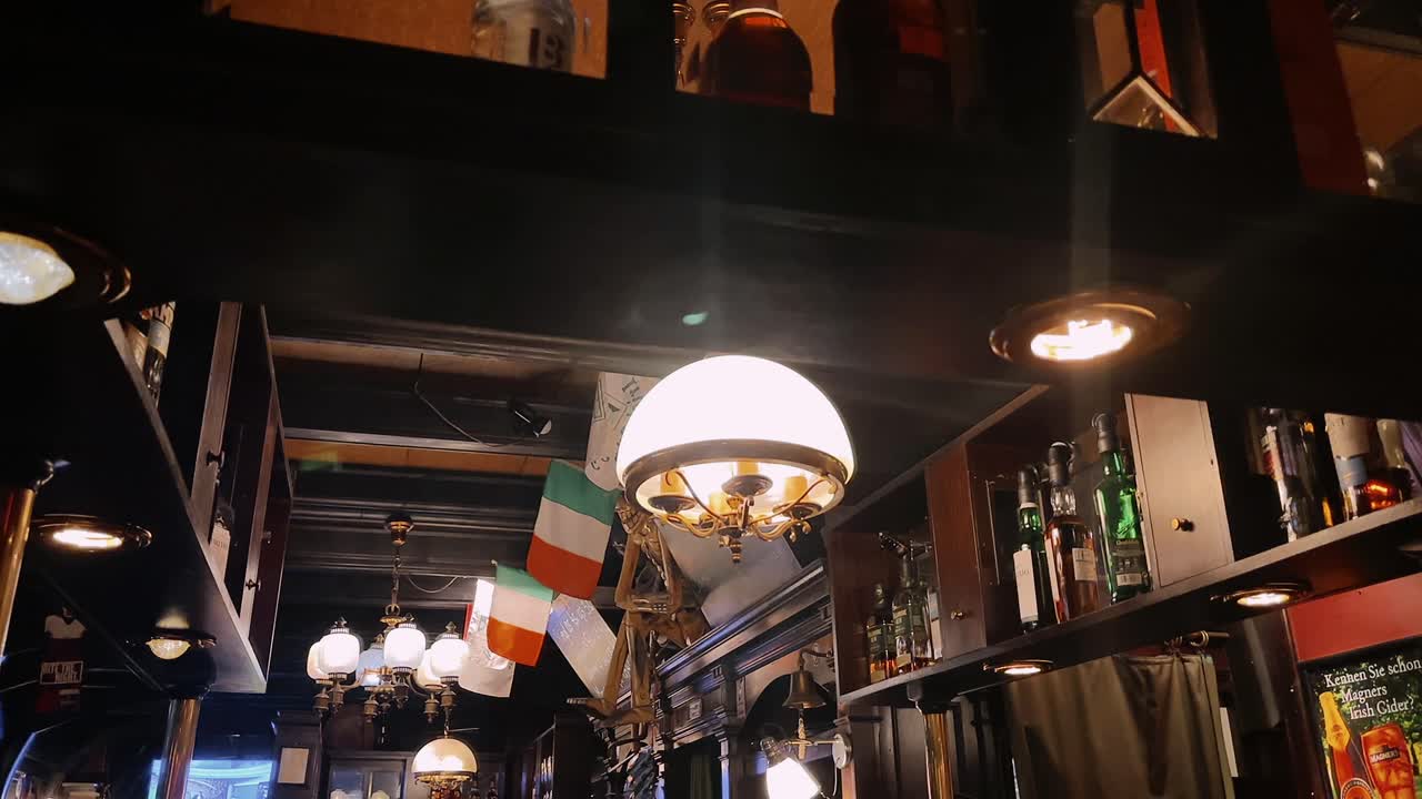 Warm lit Irish pub interior with wooden decor and flags in Vienna Austria