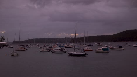 boats and breathtaking sight of purple storm clouds engulfing manly wharf