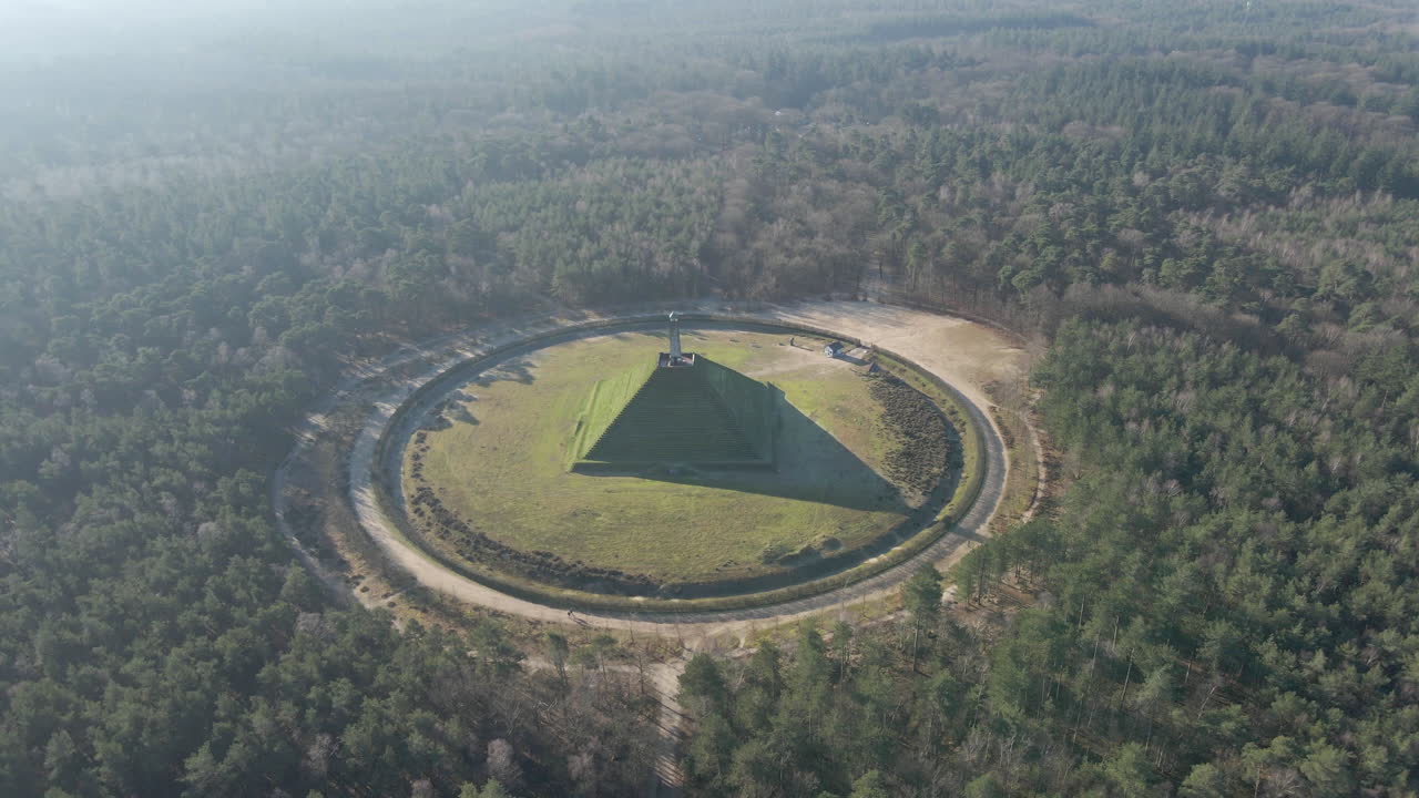 Flying towards Austerlitz pyramid in beautiful forest in the Netherlands. The Piramide van Austerlitz is a monument in the Netherlands, built in 1804 as a tribute to Napoleon Bonaparte.