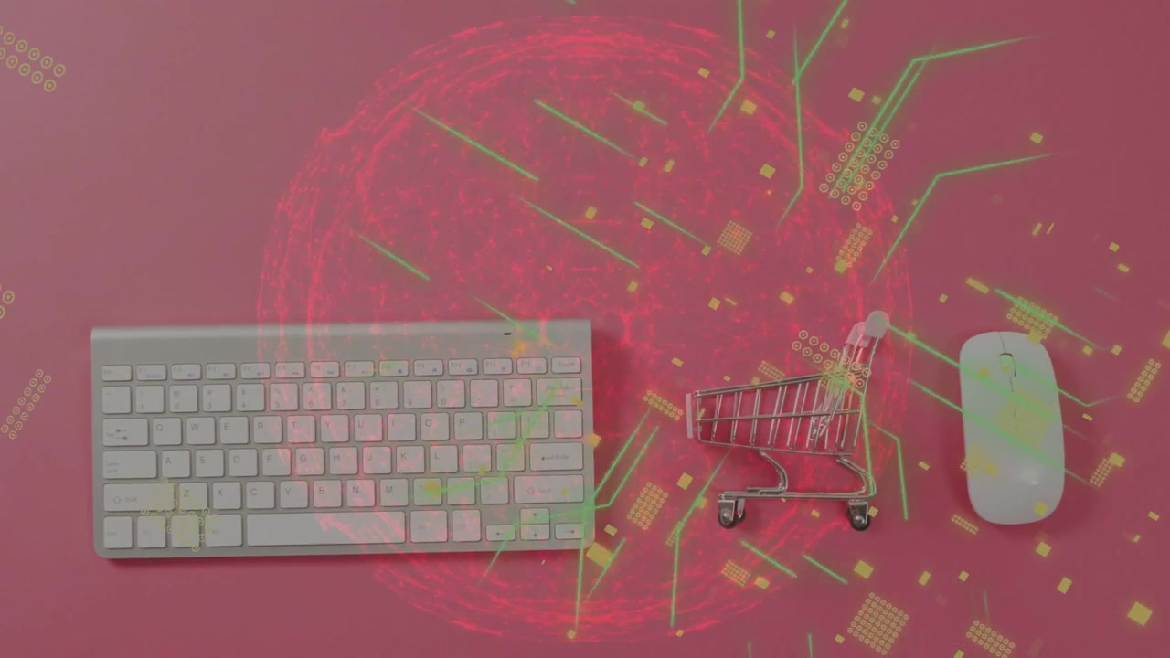 Orbe rojo apareciendo y enviando partículas de circuito sobre un teclado, un carrito y un ratón en un fondo rosa, mapeando datos.