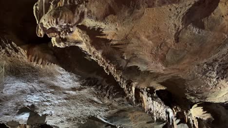 stalactites and stalagmites inside a spacious cave formation