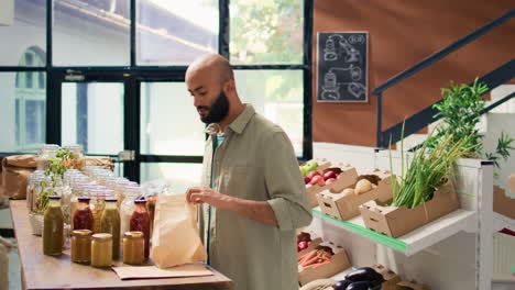 Young-man-pouring-pasta-into-bag