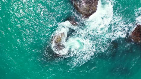 Seychelles-rocky-coast-and-rough-turquoise-sea-splashing-on-the-stones