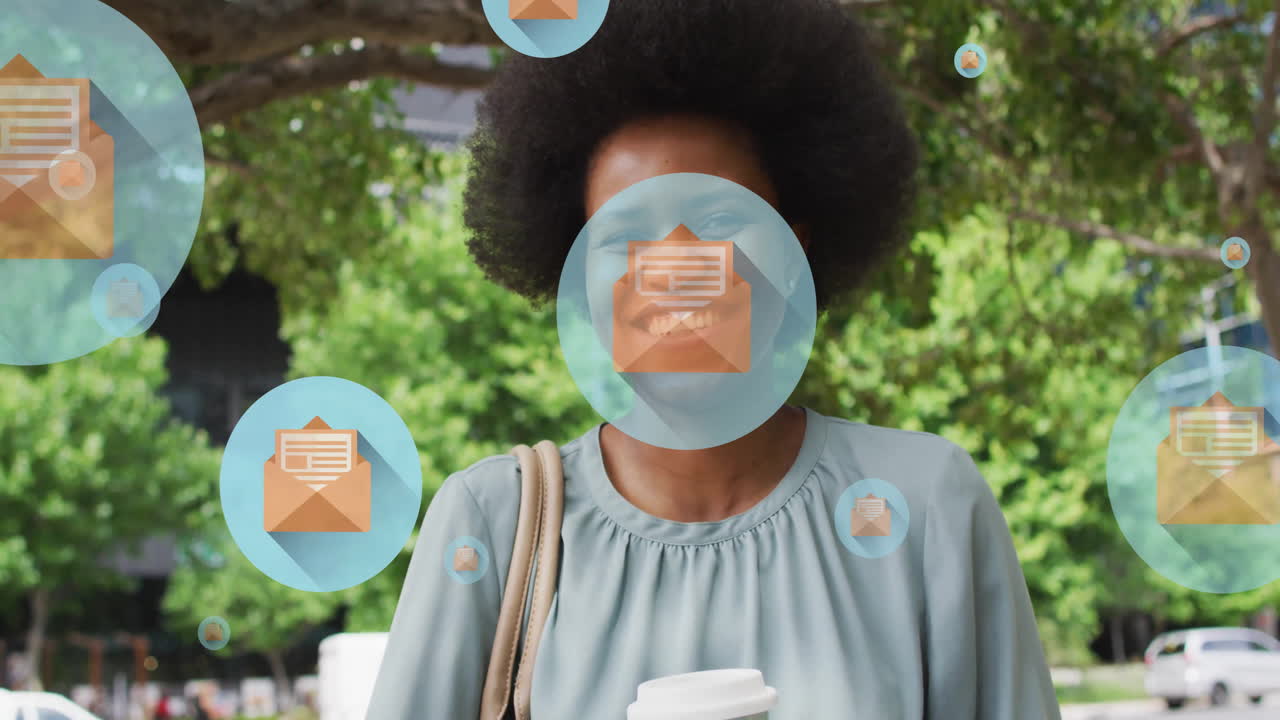 Animation of letter on envelope in circles over smiling african american woman against tree