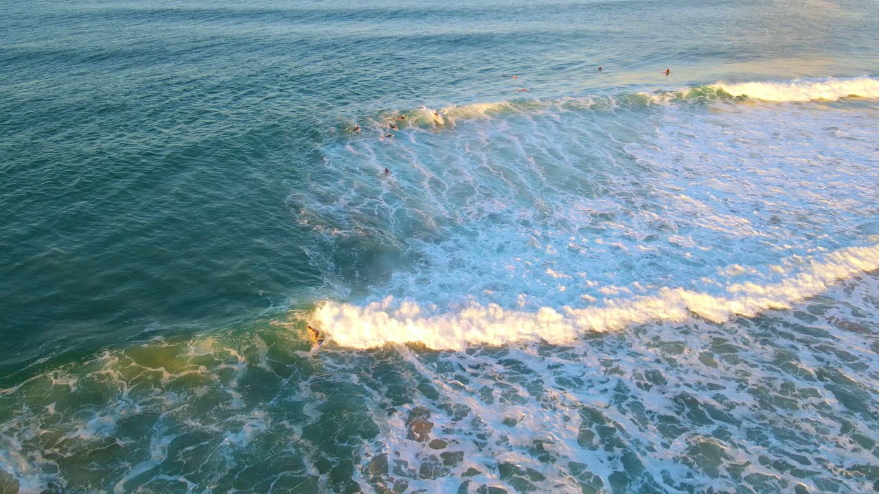 서핑 - 파도가 해변으로 돌진하는 것을 즐기는 서핑보드를 타는 남자