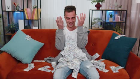 successful happy rich business man counting money cheering up with high profits, lottery game win