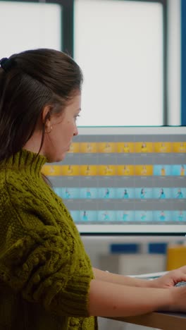 vertical video woman retoucher looking at camera smiling working in creative media agency