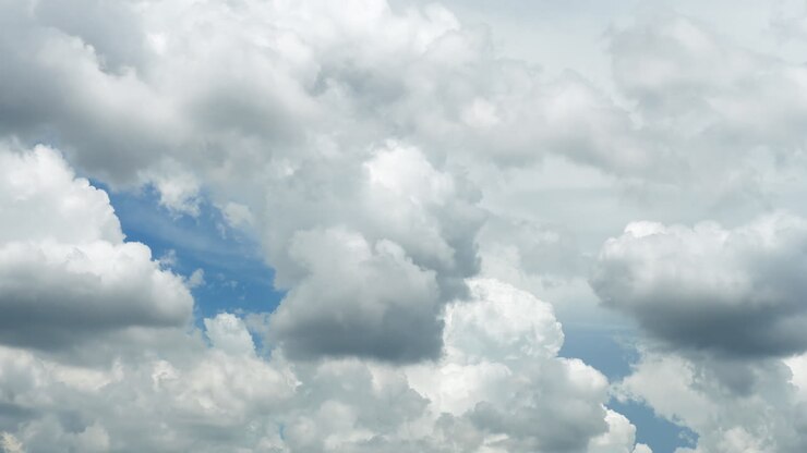 White puffy clouds and blue sky time-lapse with long second duration for background and graphics in daylight