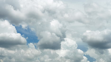 white puffy clouds and blue sky time-lapse with long second duration for background and graphics in daylight